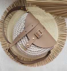 a straw hat with a handbag on top of it