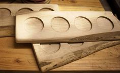 three wooden circles are sitting on top of a table next to a pair of scissors