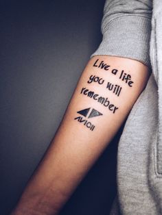 someone with a tattoo on their arm saying live a life you will remember