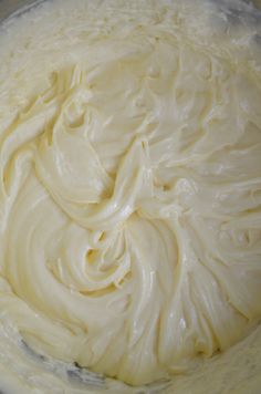 a bowl filled with whipped cream sitting on top of a table