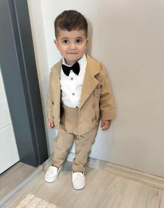 This Baby Boy Baptism 5 Piece Tuxedo Suit is custom made to order. Boy's Shirt with Short or Long Pants, Suspenders, Boy's Bow Tie, Vest.comes with free embroidery on jacket and sleeves/cuffs. You can also choose to embroider the date on one headline and the name on the other. We hand engrave the date, initials or name to make your baby's day even more special and forever unforgettable! Please visit my store for many more children's costumes and custom made clothing.. https://adykidsdesign.etsy. Beige Tuxedo, Christening Gowns For Boys, Suit Beige, Suit With Jacket, Boys Tuxedo, Boy Monogram, Baby Boy Baptism, Christening Gown