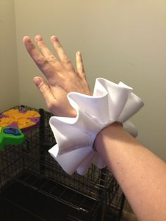 a person's hand with a white bow on it