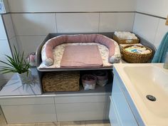 a dog bed in the corner of a bathroom