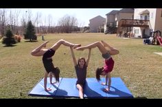 three girls doing handstands in the yard