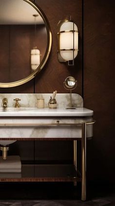 a bathroom with a marble sink and gold fixtures