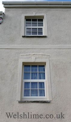 the side of a building with two windows