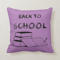 back to school pillow with books and pen on it's purple background, which says back to school