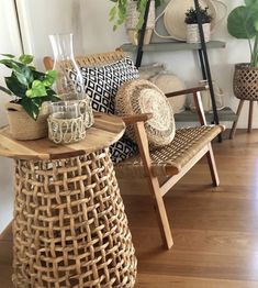 a living room filled with lots of furniture and plants on top of wooden tables next to each other