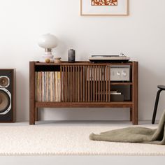 an entertainment center with speakers, record player and rug