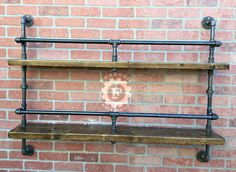 an industrial style shelf with three shelves on each side and two pipe brackets at the bottom