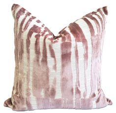 a pink and white striped pillow on a white background