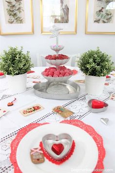 valentine's day table setting with heart shaped cookies and raspberries