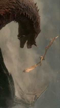 a dragon flying through the air next to another creature