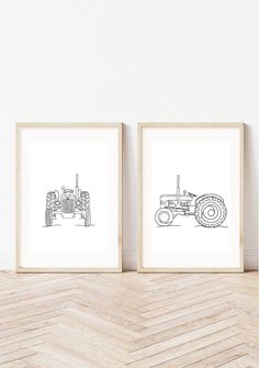 two framed drawings of tractors on a wall