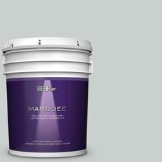 a bucket of behr marquee paint on a beige background with the lid open