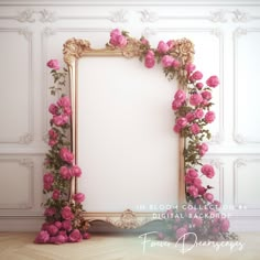 an ornate gold frame with pink flowers around it on a wooden floor in front of a white wall