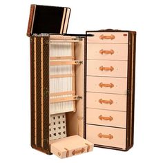 an open suitcase with many drawers and compartments on the inside, including one for sewing