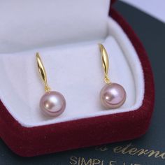 This popular earring design features AAAA quality, round freshwater pearls measuring 10-11mm. Expertly crafted with 10-11mm freshwater pearls, these classic hoop earrings are a timeless addition to any jewelry collection. These elegant and versatile earrings complement any outfit and add a touch of sophistication to your look. Made with high-quality materials, these earrings are built to last and will make a beautiful gift for yourself or a loved one. Product Details: Pearl Type: Freshwater Pear Minimalist Rose Gold Round Pearl Earrings, Elegant Hoop Earrings With Pearl Drop, Minimalist Akoya Pearl Round Earrings, Elegant Hypoallergenic Round Pearl Earrings, Minimalist Round Akoya Pearl Earrings, Rose Gold Pearl Round Earrings, Baroque Pearl Pendant Earrings, Formal Round Pearl Earrings With Ear Wire, Akoya Pearl Round Earrings For Pierced Ears