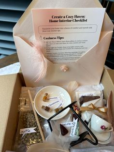 an open box filled with assorted items like spoons, tea bags and cookies