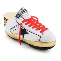 a pair of white shoes with red laces and leopard print on the bottom,