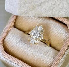 an engagement ring in a box with the lid open to show it's inside