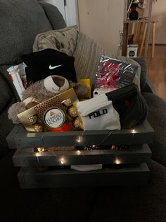 a teddy bear sitting on top of a coffee table next to a bag and other items