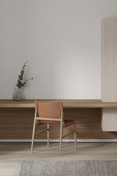 a chair sitting on top of a wooden table next to a vase filled with flowers