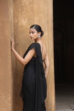 Featuring Black silk corset with mirror, thread embroidered paired with georgette drape saree with detailed and detachable belt. Fabric - Silk, Georgette Components - 3 Colour - Black Embroidery details - Machine Embroidery Delivery time - 2-3 weeks Washing Instructions - Dry-clean Mirror Blouse, Silk Corset, Embroidery Mirror, Ruffle Saree, Drape Saree, Black Drapes, Black Embroidery, Black Corset, Silk Embroidery