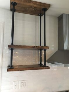 two wooden shelves on the wall in a kitchen