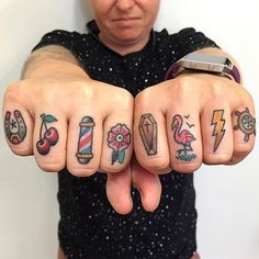 a person with many tattoos on their fingers