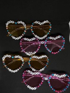 five pairs of sunglasses with beaded trimmings on the sides and one pair is purple