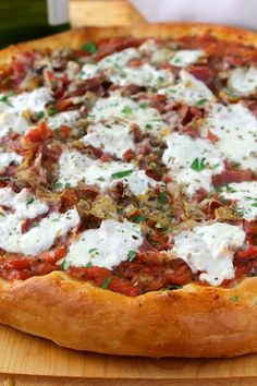 a pizza sitting on top of a wooden cutting board