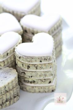 cookies with white frosting in the shape of hearts