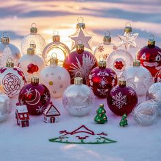 a group of christmas ornaments sitting in the snow