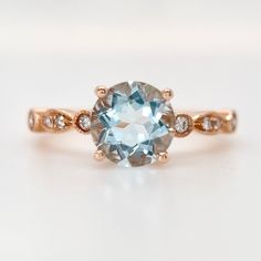 A classic round Aquamarine stone set in 14k rose gold band with art deco style. Matching band not included. Metal: Solid 14k Rose Gold (18k/Platinum available, please contact us for pricing) Band width: 1.8-2mm Center Stone: Blue Aquamarine Cut:  Round Cut  Size: 6.5mm  Accessory stone: Natural Round diamonds, 0.12ctw , SI Clarity, H Color Please contact us if you need any of our service: * Custom your very own ring, * Ring Resizing, * Metal Change (10/14/18k White/Yellow/Rose Gold), * Diamond U Classic Rose Gold Topaz Ring, Rose Gold Round Topaz Birthstone Ring, Rose Gold Topaz Ring With Birthstone, Art Deco Rose Gold Round Diamond Ring, Rose Gold Art Deco Diamond Ring, Classic 14k Rose Gold Rings With Accent Stones, Classic Rose Gold Birthstone Ring With Round Cut, Classic Rose Gold Round Cut Birthstone Ring, Rose Gold Topaz Ring With Gemstone