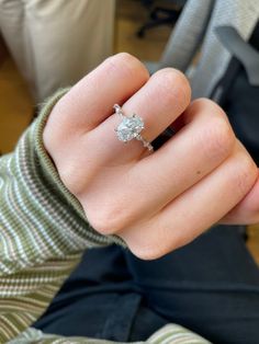 a close up of a person's hand with a ring on it