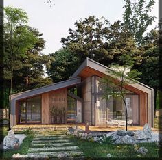 a small wooden house in the middle of some rocks and grass with trees around it