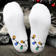 Introducing our Christmas Lights - Personalized Crew Socks, the perfect festive accessory to light up your holiday season. These cozy crew socks aren't just for keeping your feet warm; they add a touch of Christmas magic to your outfit. Ideal for anyone looking to elevate their holiday attire or make a unique and personalized gift for Christmas stocking stuffers or fellow cat lovers, our Christmas Lights socks are designed to spread the warmth and joy of the season with every step.MESSAGE: Christmas Lights for Cat Lovers. PRODUCT DETAILS: Material: 90% polyester and 10% spandex. Measures: 3.5 x 17.7 inches (9 x 45 cm). Superior Mid-calf height. Novelty Christmas Gift Socks, White Winter Gift Socks, White Socks For Winter Gifts, White Winter Socks As Gift, Novelty White Socks For Winter, White Novelty Socks For Winter, Novelty White Socks For Stocking Stuffers, Holiday Attire, Sock Packs