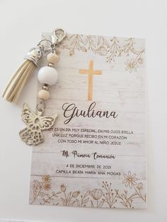 a rosary with a cross on it next to a card that says guulana