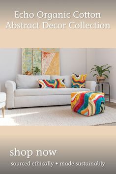 a living room with white furniture and colorful pillows