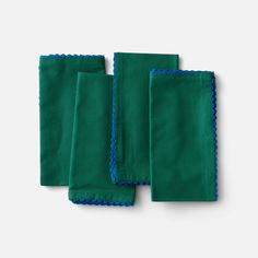 three green napkins with blue trim on them