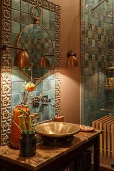 a bathroom with a sink, mirror and light fixture on the wall next to it