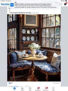 an image of a table with two chairs and a bench in front of a window