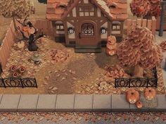 a fake house with pumpkins on the ground in front of it and trees around