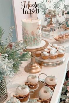 a table topped with cakes and cupcakes on top of it's sides