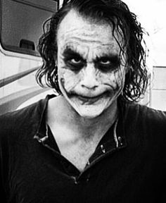 a man dressed as the joker in black and white