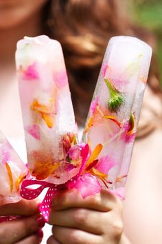 a close up of a vase with flowers in it and water on the inside,