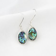 Why abalone? Because its one of the most beautiful shells in the ocean. Wire wrapped, these abalone shells give a pop of color you are guaranteed to love! Please note, all abalone shells vary. The colors include dark and light blues, greens and hints of purple, reds, and browns. Patterns vary from simple to complex swirls, stripes, and anything between! Get these earrings in the perfect light and the colors will shine and glow beautifully! *Also available in gold filled, large and small circles* Sterling Silver Shell As Gift, Nickel-free Shell Gift, Elegant Abalone Shell Jewelry For Beach, Handmade Teardrop Shell Gift, Abalone Shell Jewelry Gift, Abalone Shell Jewelry For Pierced Ears As Gift, Nickel-free Ocean-inspired Shell As Gift, Silver Dangle Shell Earrings For Gift, Abalone Shell Earrings For Pierced Ears As A Gift