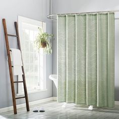 a bathroom with a ladder and shower curtain