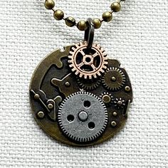 a necklace with an old clock and gears on it